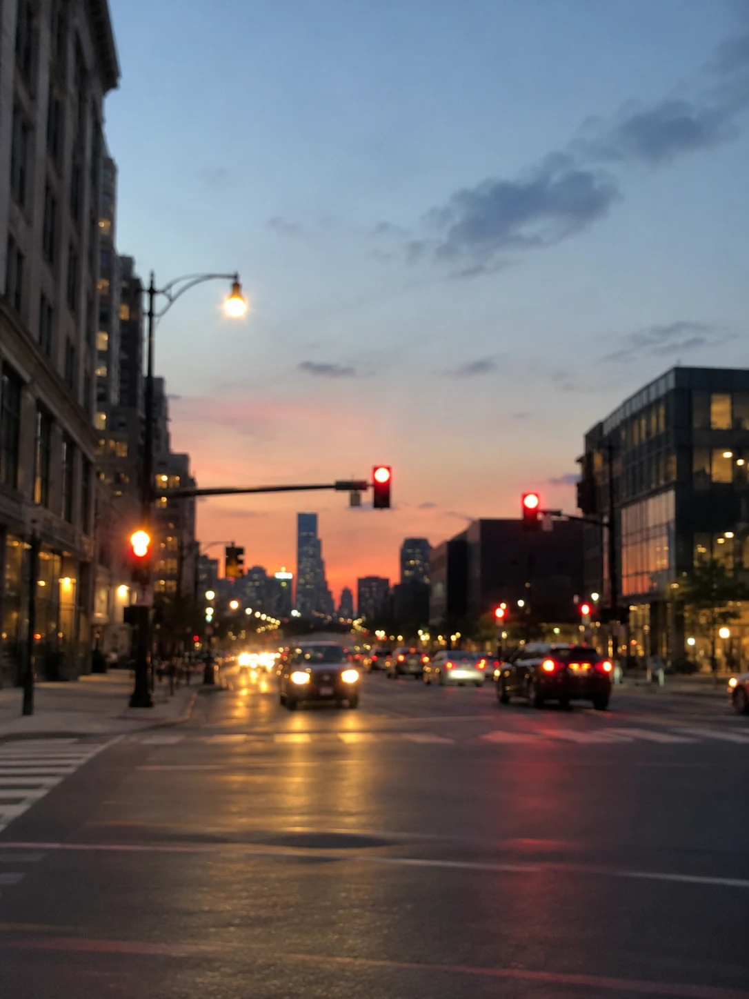 Blurry photo of a city intersection at sunset