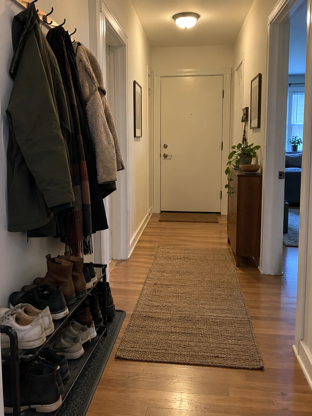 Hallway with coats, shoes and a runner rug